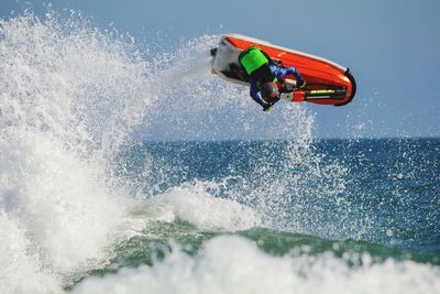 Low angle view of man performing stunt on jet boat