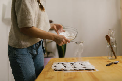 Young woman making christmas cookies