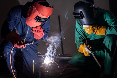 Workers welding metal