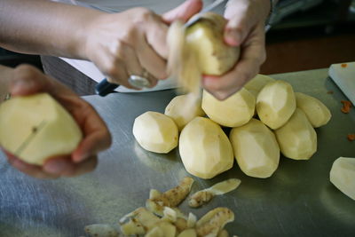 Midsection of person preparing food on cutting board