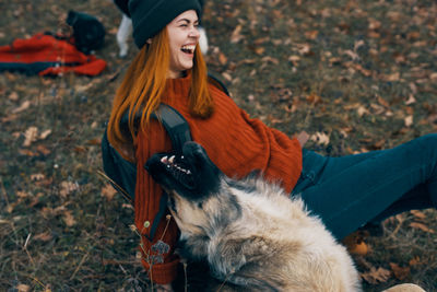 Woman with dog on field