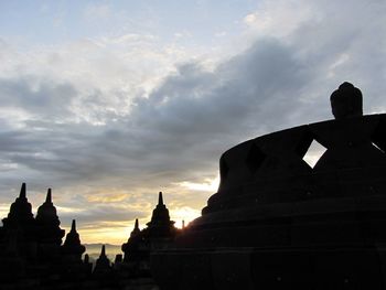 Low angle view of silhouette temple against sky during sunset