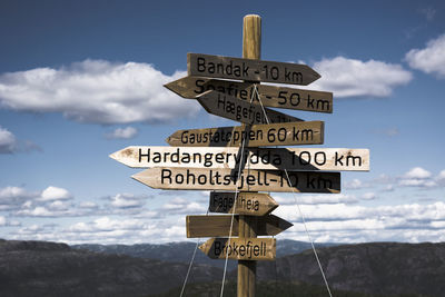 Low angle view of road sign against sky
