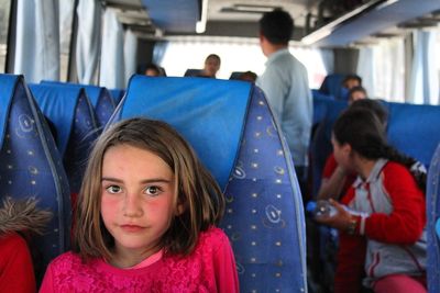 Portrait of girl sitting in bus