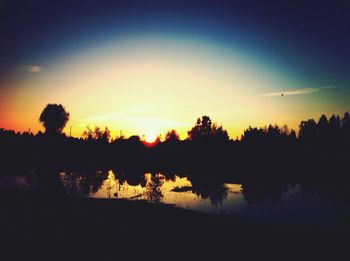 Scenic view of lake at sunset