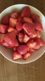 High angle view of strawberries in bowl on table