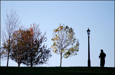 Man on field against clear sky