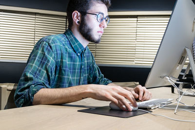 Close-up of man using computer