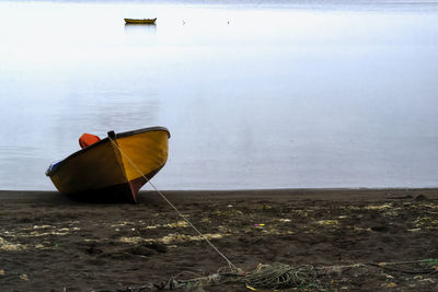 Boat on shore at beach