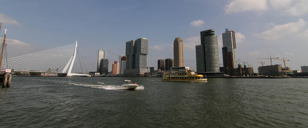 View of city by river against buildings