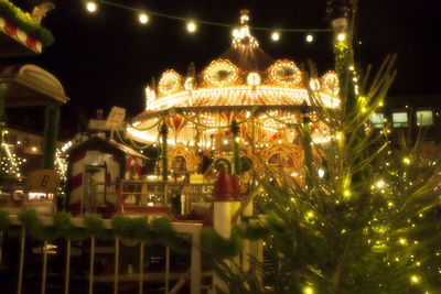 Illuminated carousel at night