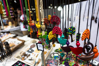 Close-up of multi colored necklaces hanging in market