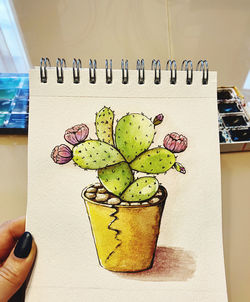 Close-up of hand holding fruit on table