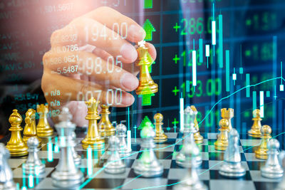 Chess game on chess board behind businessman background. business concept for financial information