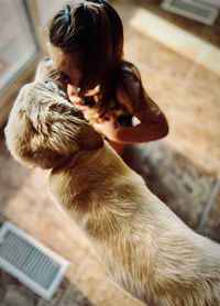 Side view of little girl with dog