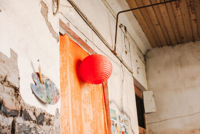 Low angle view of chinese lantern on old house door
