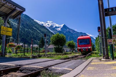 Train by railroad track against sky