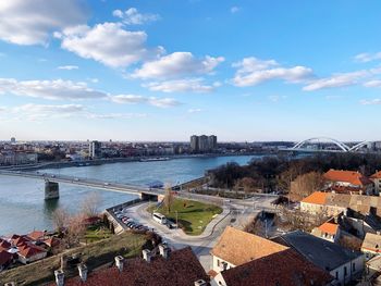 High angle view of river amidst buildings in city against sky