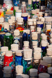 Full frame shot of multi colored bottles for sale at market