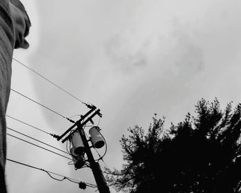Low angle view of power lines against sky
