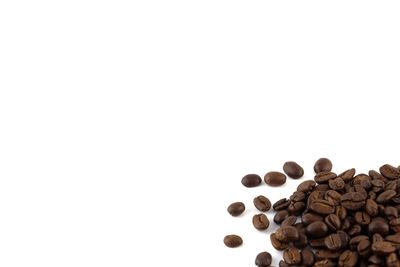 High angle view of coffee beans against white background