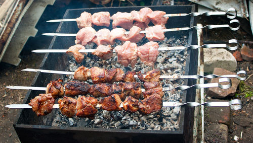 High angle view of meat on barbecue grill