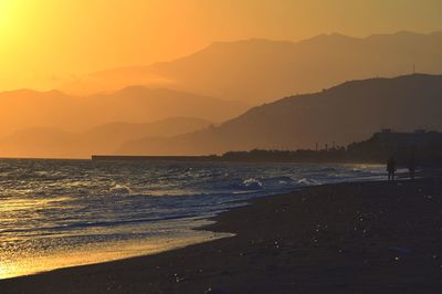Scenic view of beach against sky during sunset