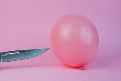 Close-up of pink balloons against blue background