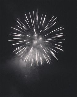 Low angle view of firework display at night