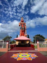 Sculpture of temple against cloudy sky