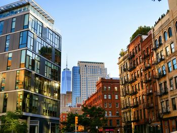 Buildings in city against clear sky