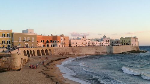 View of buildings at beach against clear sky