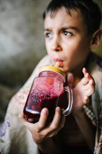 Boy drinking juice in container