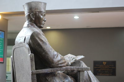 Low angle view of statue against illuminated sculpture