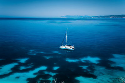 High angle view of sailboat sailing in sea against sky