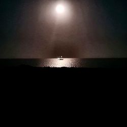 Scenic view of sea against sky at night