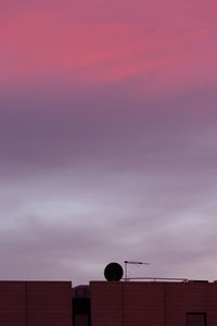 Low angle view of building against cloudy sky