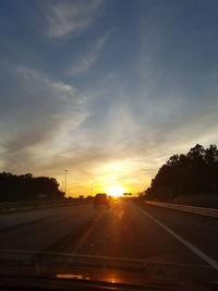 Cars on road at sunset