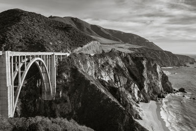 Arch bridge over sea against sky