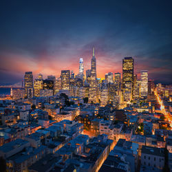 Aerial view of illuminated buildings in city at night