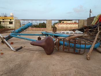 Broken bicycle against sky