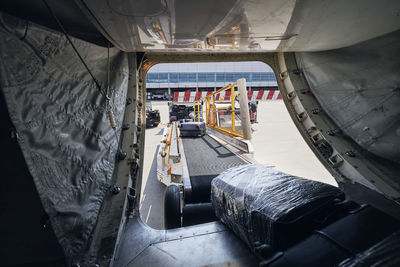 Loading of luggage to airplane. suitcases on conveyor belt to plane.