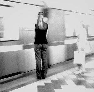 Full length of woman standing by railing