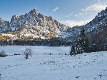 Scenic view of snow covered mountains against sky