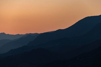 Scenic view of silhouette mountains against sky during sunset