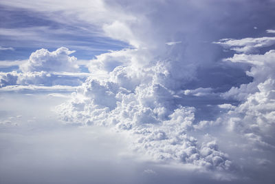 Cumulonimbus, towering and many nimbus clouds in the blue sky, airplane view.