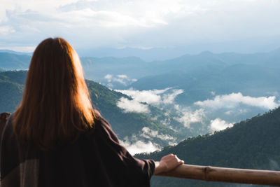 Rear view of woman looking at mountains