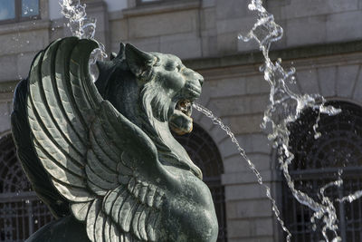 Low angle view of statue against fountain