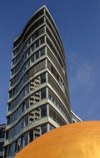 Low angle view of office building against sky