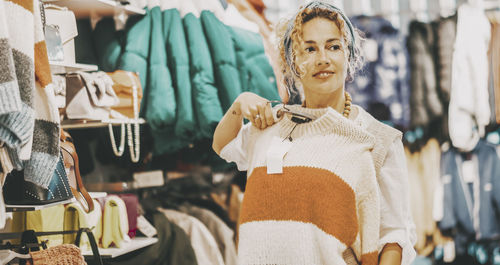 Portrait of young woman standing in store